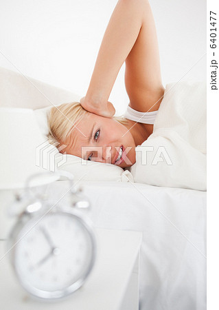 Portrait of an alarmclock waking up a woman Portrait of an alarmclock waking up a woman 6401477