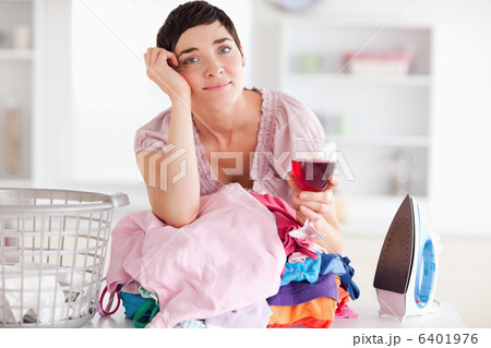 Sad Woman with wine and a pile of clothes Sad Woman with wine and a pile of clothes 6401976