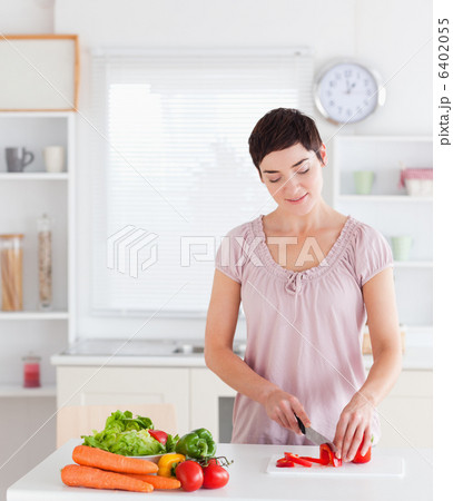 Gorgeous woman cutting vegetables Gorgeous woman cutting vegetables 6402055