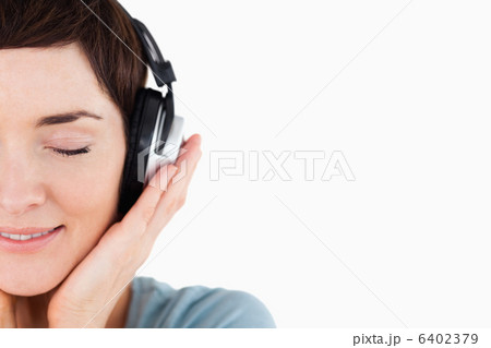 Close up of a delighted woman enjoying some music 6402379