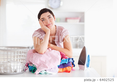 Bored Woman with a pile of clothes Bored Woman with a pile of clothes 6402525