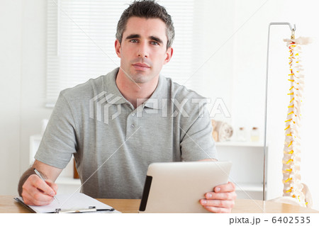 Male Doctor working with a tablet and a chart Male Doctor working with a tablet and a chart 6402535