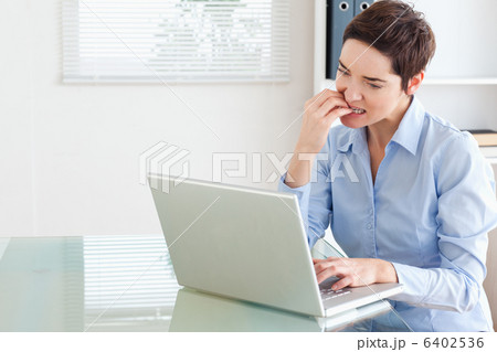 Angry brunette Businesswoman with a laptop 6402536