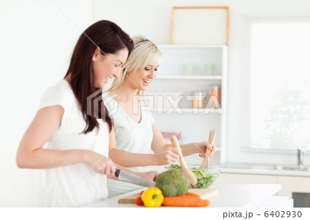 Joyful young Women preparing dinner 6402930