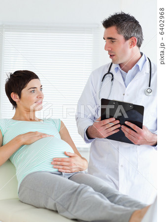 Doctor talking to a pregnant woman 6402968