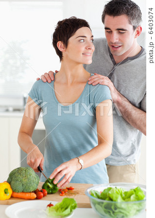 Husband peeking over his wifes shoulder 6403074