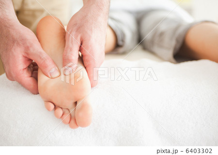 Male masseur massaging a womans foot 6403302