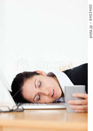 Beautiful businesswoman sleeping in office 6403400