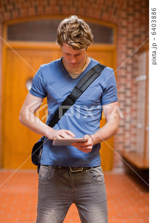 Portrait of a handsome student using a tablet computer Portrait of a handsome student using a tablet computer 6403886