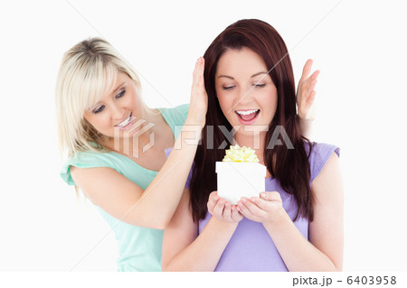 Gorgeous woman gifting her friend 6403958