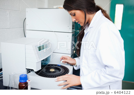 Scientist using a centrifuge 6404122