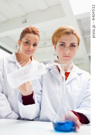 Portrait of cute science students doing an experiment Portrait of cute science students doing an experiment 6404532