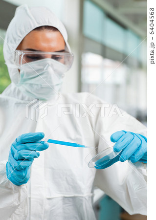 Portrait of a protected female science student dropping blue liq Portrait of a protected female science student dropping blue liq 6404568