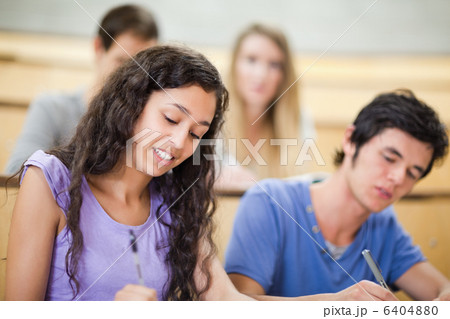 Smiling students writing Smiling students writing 6404880