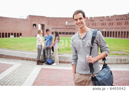 Student posing while his classmates are talking 6405042