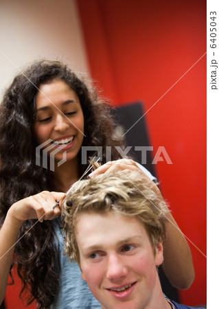 Portrait of a female hairdresser cutting hair 6405043