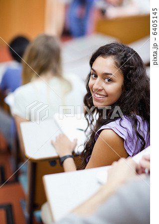 Portrait of a smiling student being distracted 6405145
