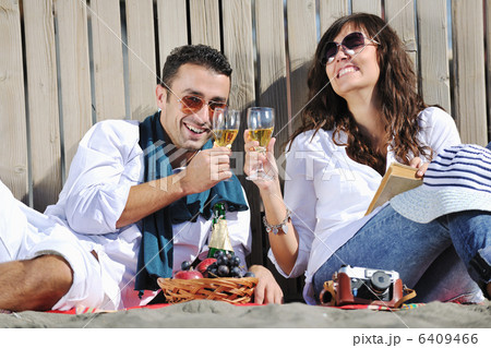 young couple enjoying picnic on the beach young couple enjoying picnic on the beach 6409466