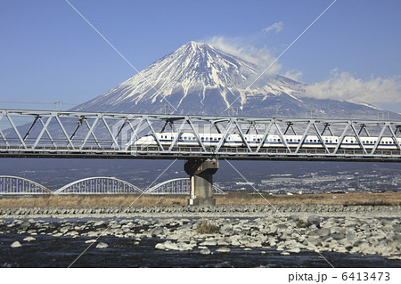 富士山と富士川橋梁を通る新幹線の写真素材