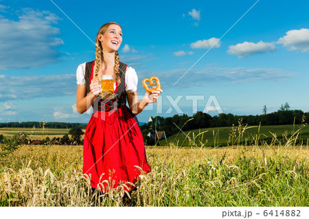 woman with tracht, beer and pretzel in Bavaria 6414882