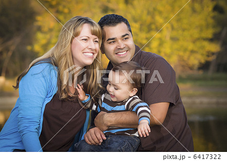 Happy Mixed Race Ethnic Family Playing In The Park 6417322