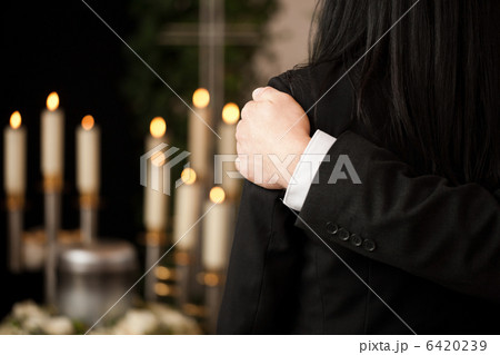 People at funeral consoling each other People at funeral consoling each other 6420239