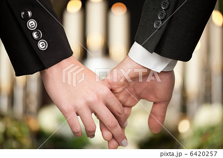 People at funeral consoling each other 6420257