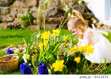 Girl on Easter egg hunt with eggs Girl on Easter egg hunt with eggs 6421674