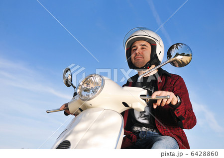 young man on ride scooter young man on ride scooter 6428860