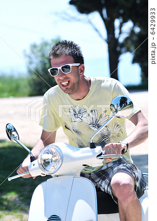 young man ride retro scooter young man ride retro scooter 6429933
