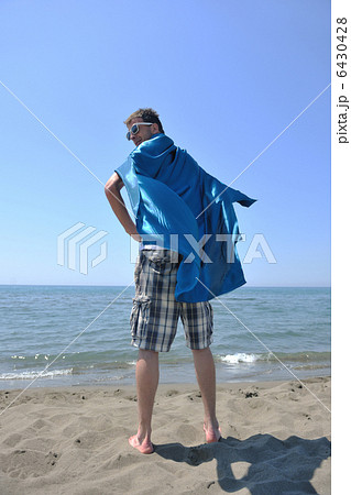 funny superhero standing on beach funny superhero standing on beach 6430428