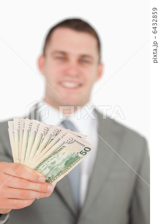 Portrait of a smiling businessman showing notes 6432859