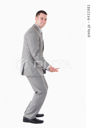 Portrait of a smiling businessman carrying something 6432981
