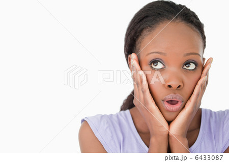 Close up of woman being afraid against a white background 6433087
