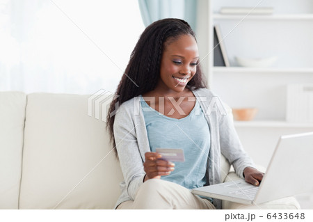 Woman in living room shopping online 6433648