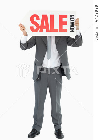 Businessman with sign in front of his head 6433939