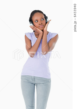 Close up of woman enjoying music with headphones on white backgr 6433940