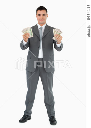 Successful businessman presenting banknotes 6434113