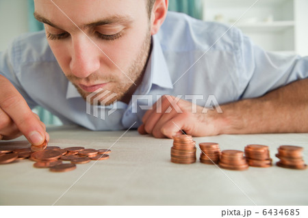 Businessman counting coins Businessman counting coins 6434685