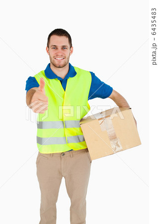 Smiling young delivery man giving approval Smiling young delivery man giving approval 6435483