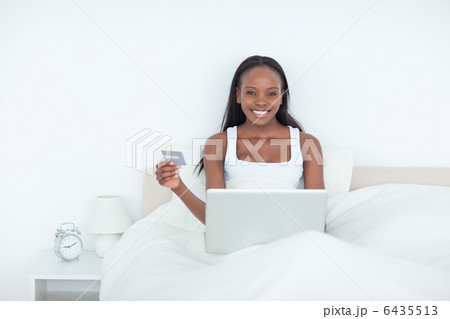 Smiling woman booking her holidays online Smiling woman booking her holidays online 6435513