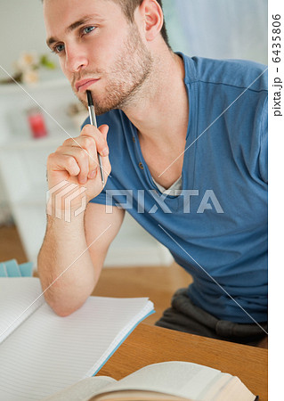 Young student doing his homework 6435806