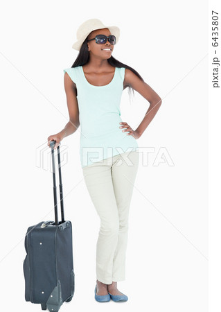 Happy smiling young woman with her suitcase Happy smiling young woman with her suitcase 6435807