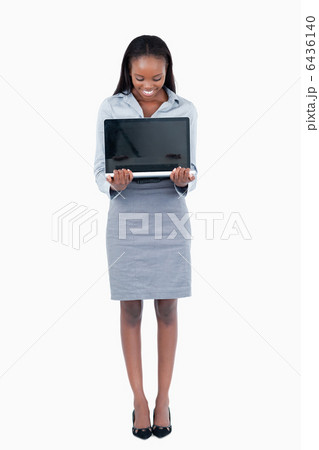 Portrait of a businesswoman showing a laptop 6436140