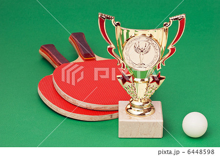 sports awards and  tennis racquets on  green table 6448598
