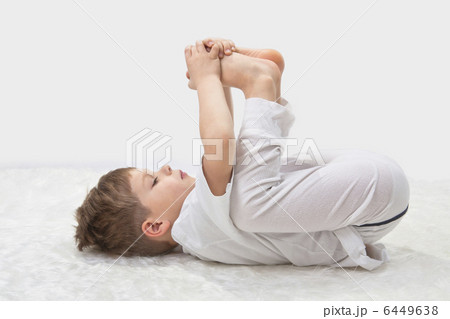 Childrens yoga. The little boy does exercise. 6449638