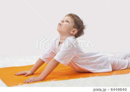 Childrens yoga. The little boy does exercise. Childrens yoga. The little boy does exercise. 6449640