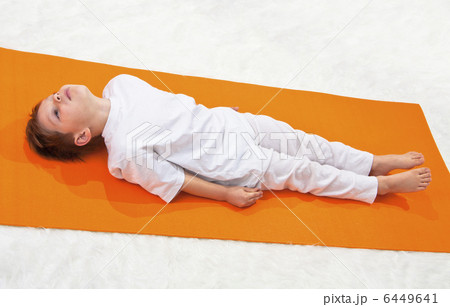 Childrens yoga. The little boy does exercise. 6449641