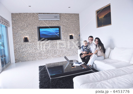 happy young family have fun with tv in backgrund happy young family have fun with tv in backgrund 6453776
