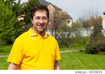 Portrait of adult active healthy man standing relaxed at his bac 6459654